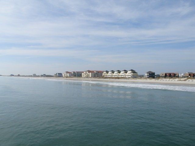 A large body of water with a beach in the background