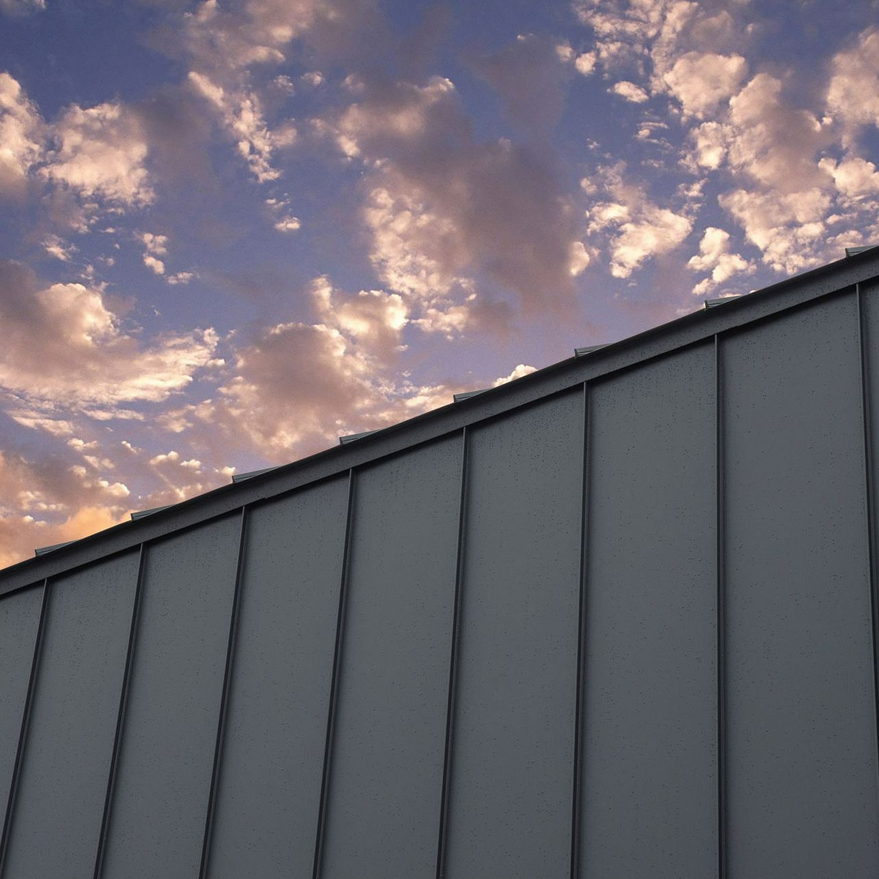 A building with a cloudy sky in the background