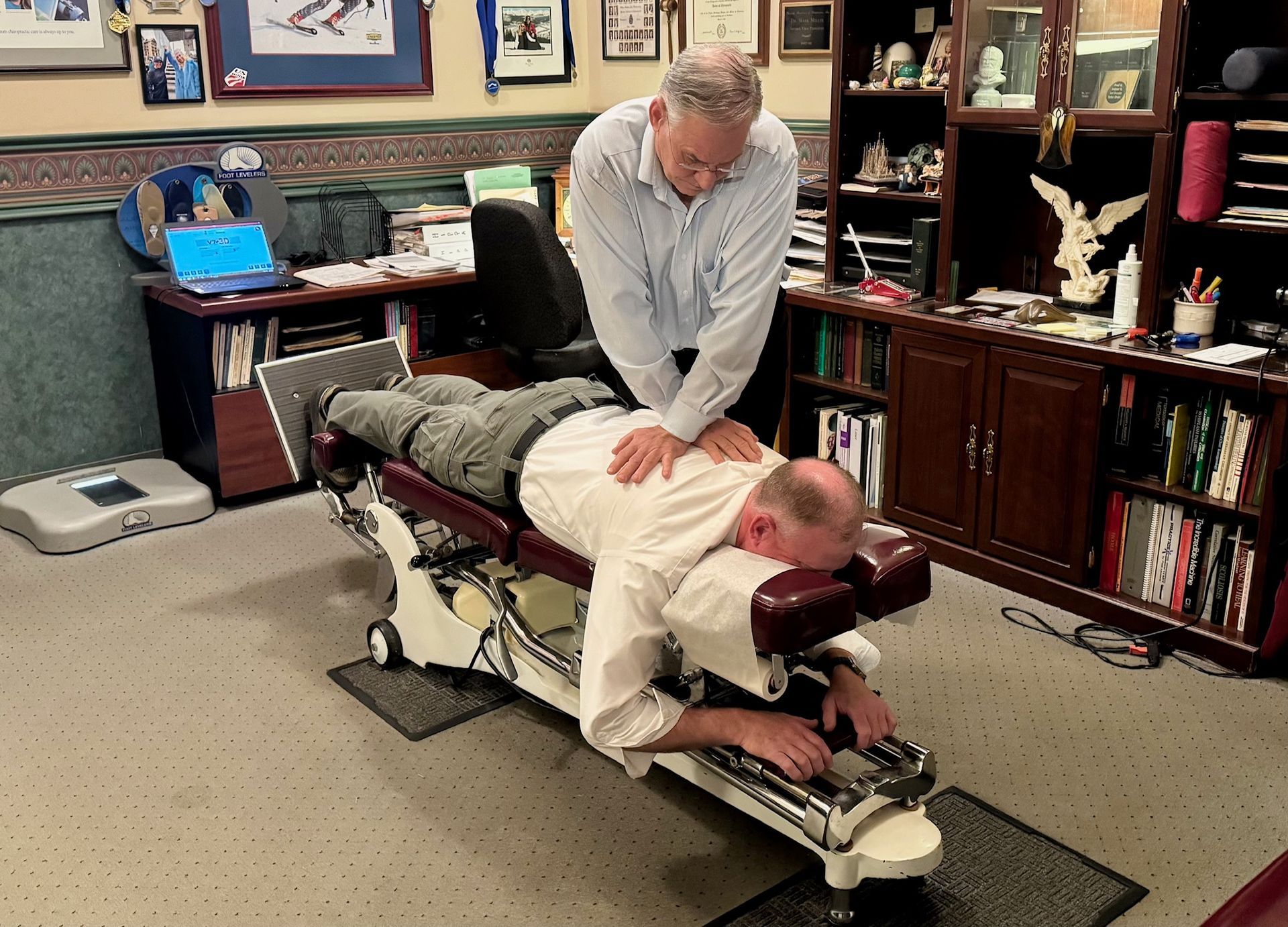 Chiropractor Fixing Elder Man's Spine — Winchester, KY — Miller Chiropractic Centre Inc PSC Chiropractor Fixing Elder Man's Spine — Winchester, KY — Miller Chiropractic Centre Inc PSC