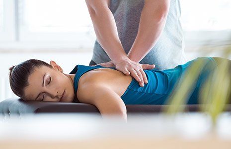 Woman Getting Her Back Treated — Winchester, KY  — Miller  Chiropractic Centre Inc PSC