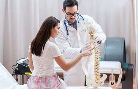 Chiropractor With Spine Skeleton — Winchester, KY  — Miller  Chiropractic Centre Inc PSC