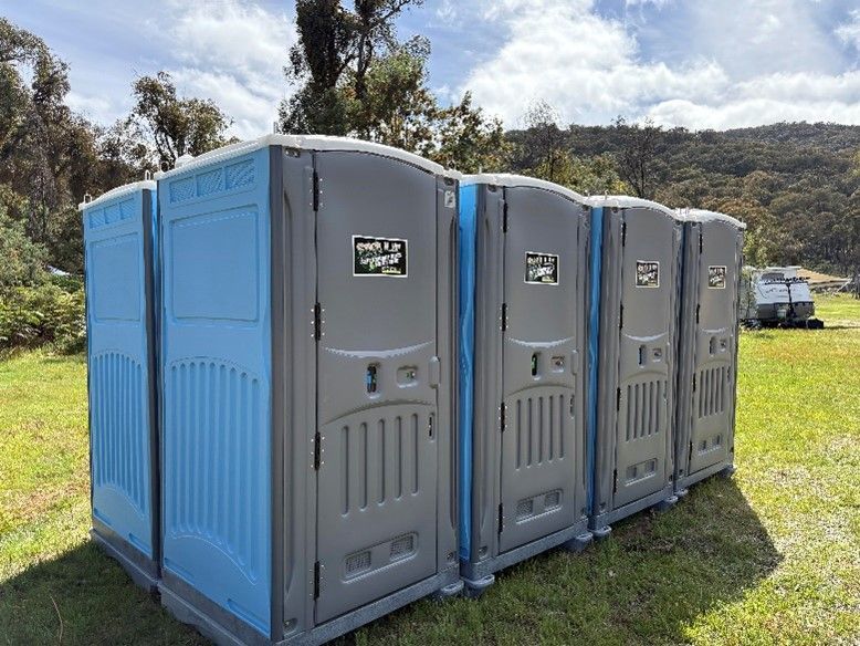 Rows of portable toilet rooms for temporary usage.