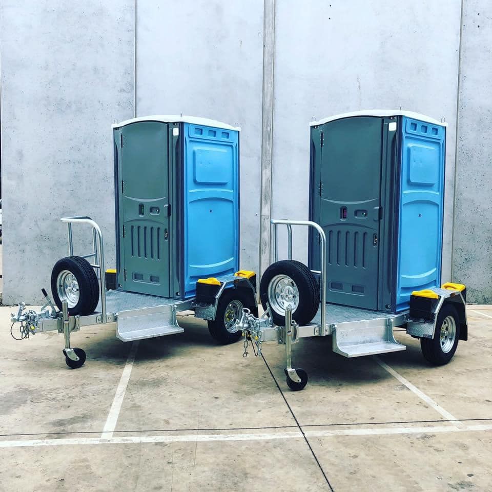 Two blue portable toilets for hire