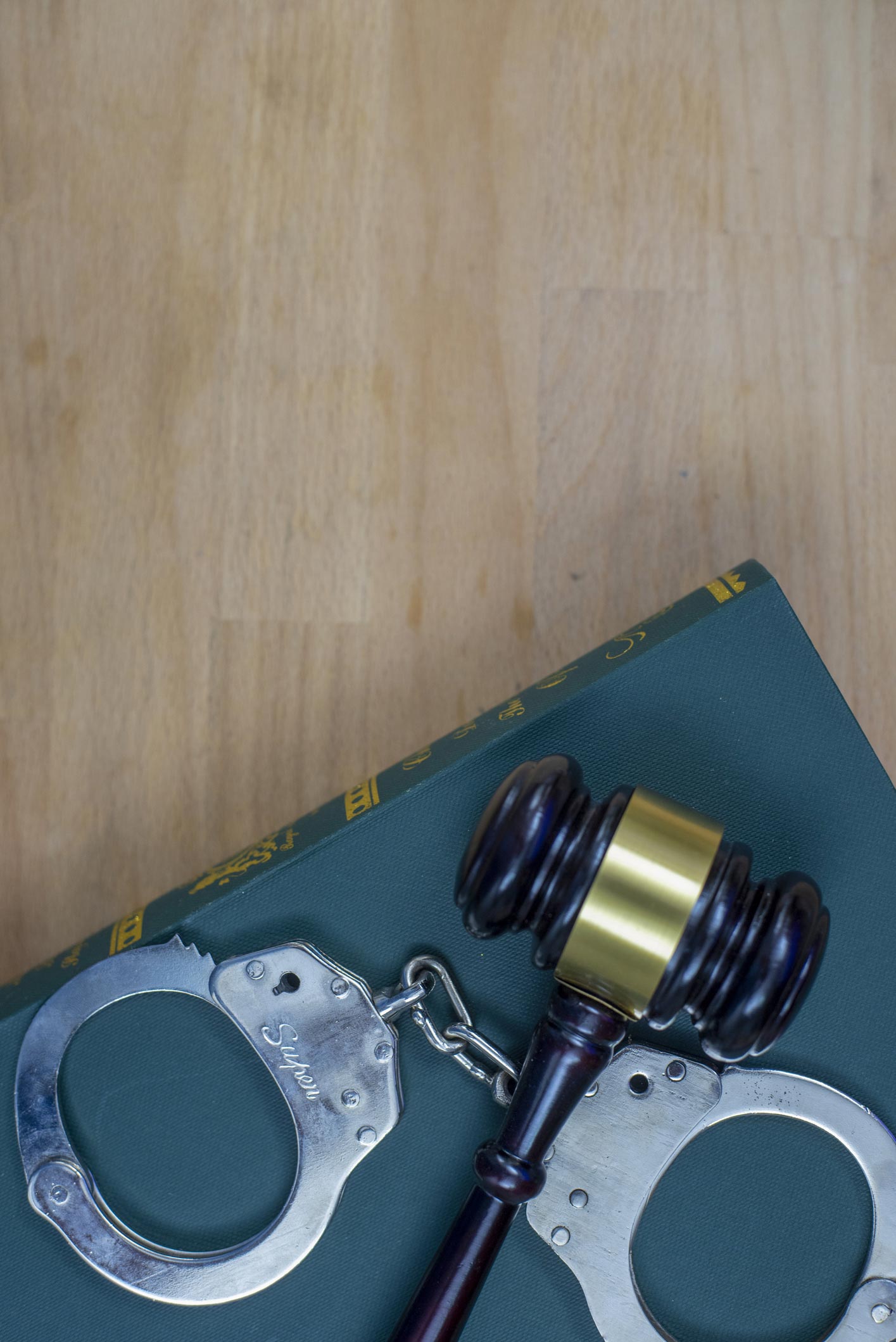 Gavel and handcuffs on the law book — San Antonio, TX — A-Action Bail Bonds