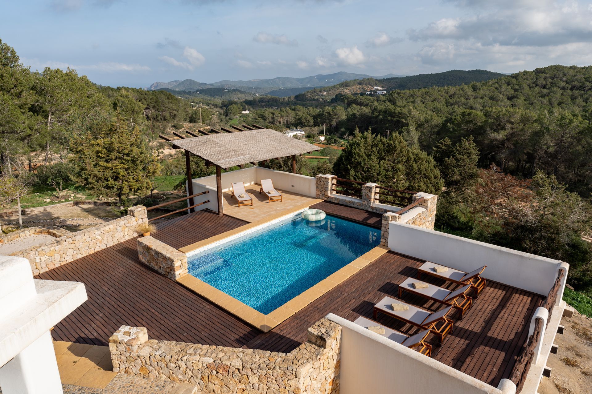 Aerial view of a pool terrace and olive grove views