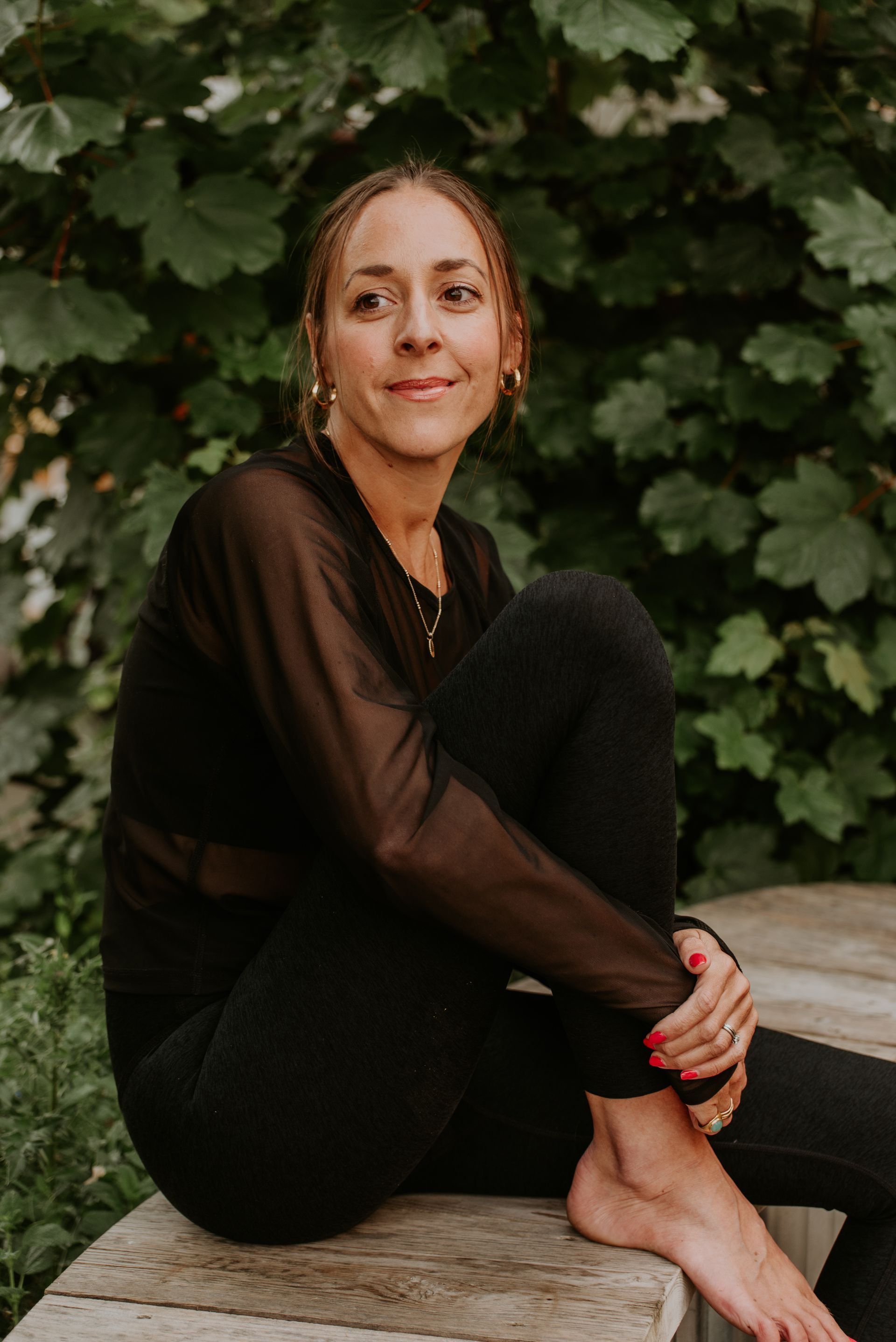 A lady in brown top sitting outside 
