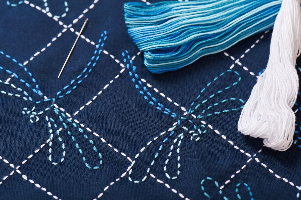 A Close Up Of A Needle And Thread On A Piece Of Fabric — Coastal Monogramming In Maroochydore, QLD