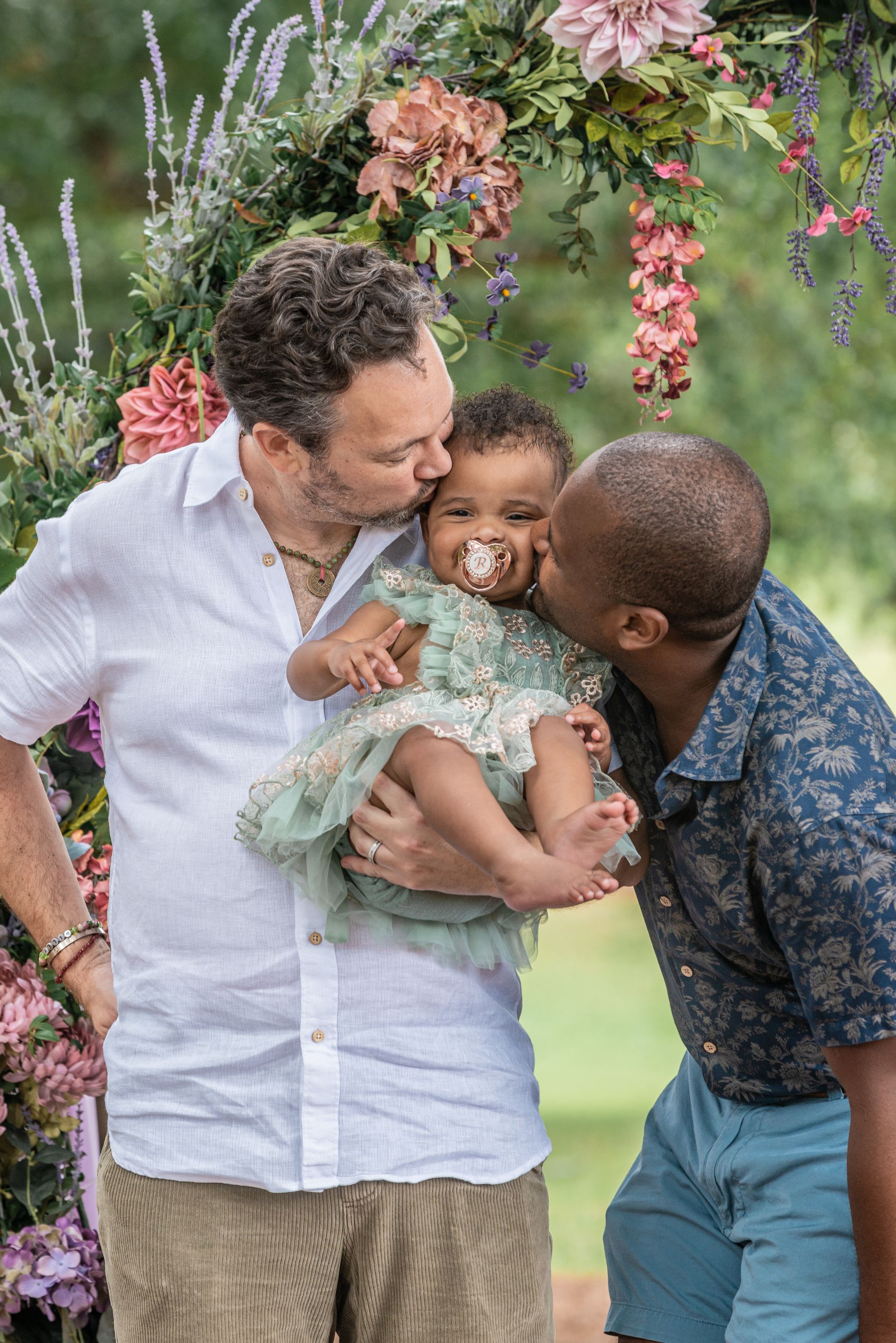 fathers kissing toddler on cheek