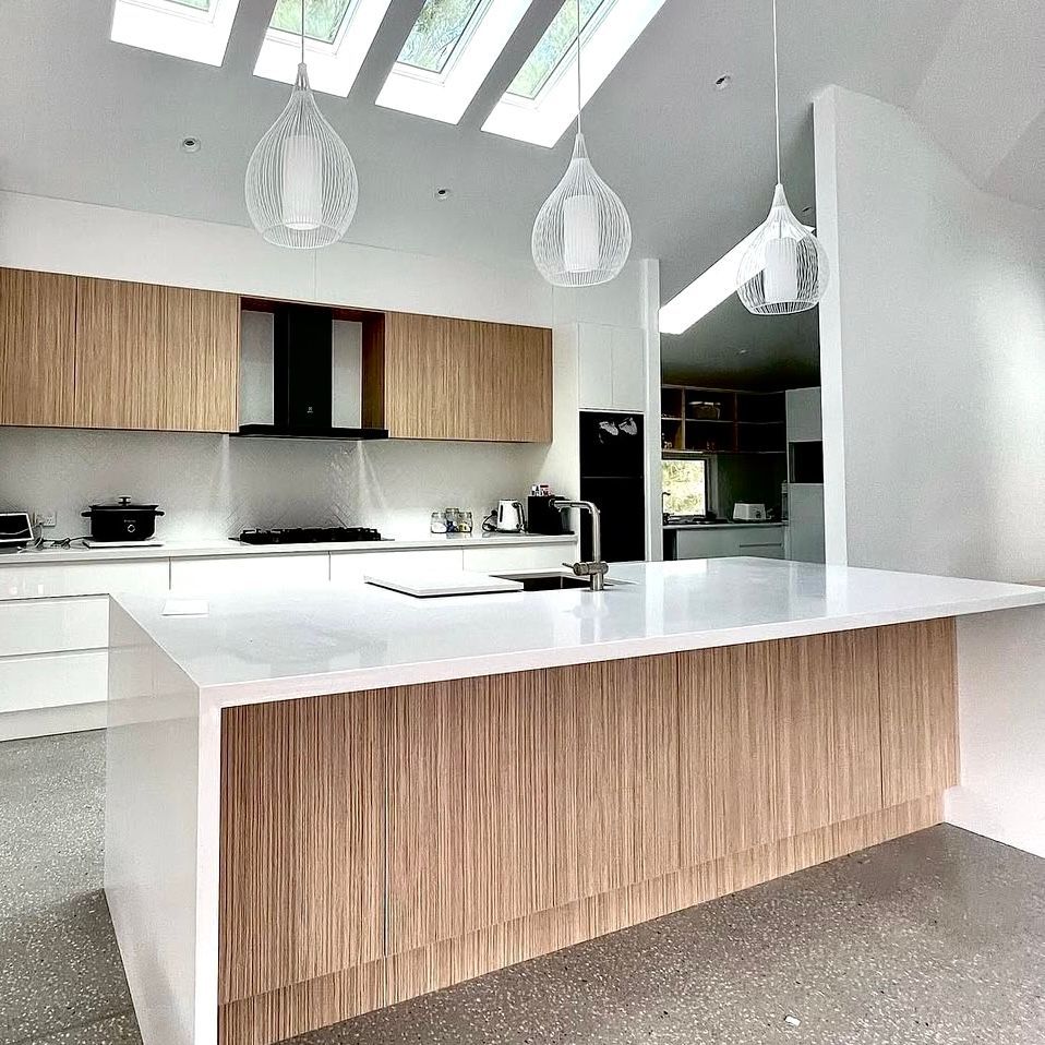 A Kitchen With a Large Island and Stools around it — Kenross Kitchens In Woy Woy, NSW