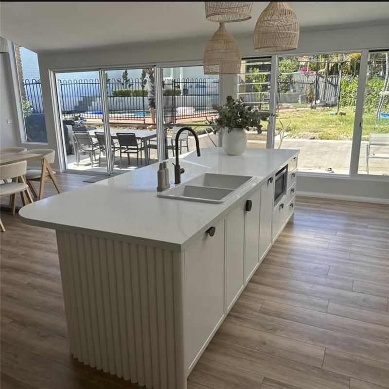 A Kitchen With a Large Island and a Sink — Kenross Kitchens In Erina, NSW