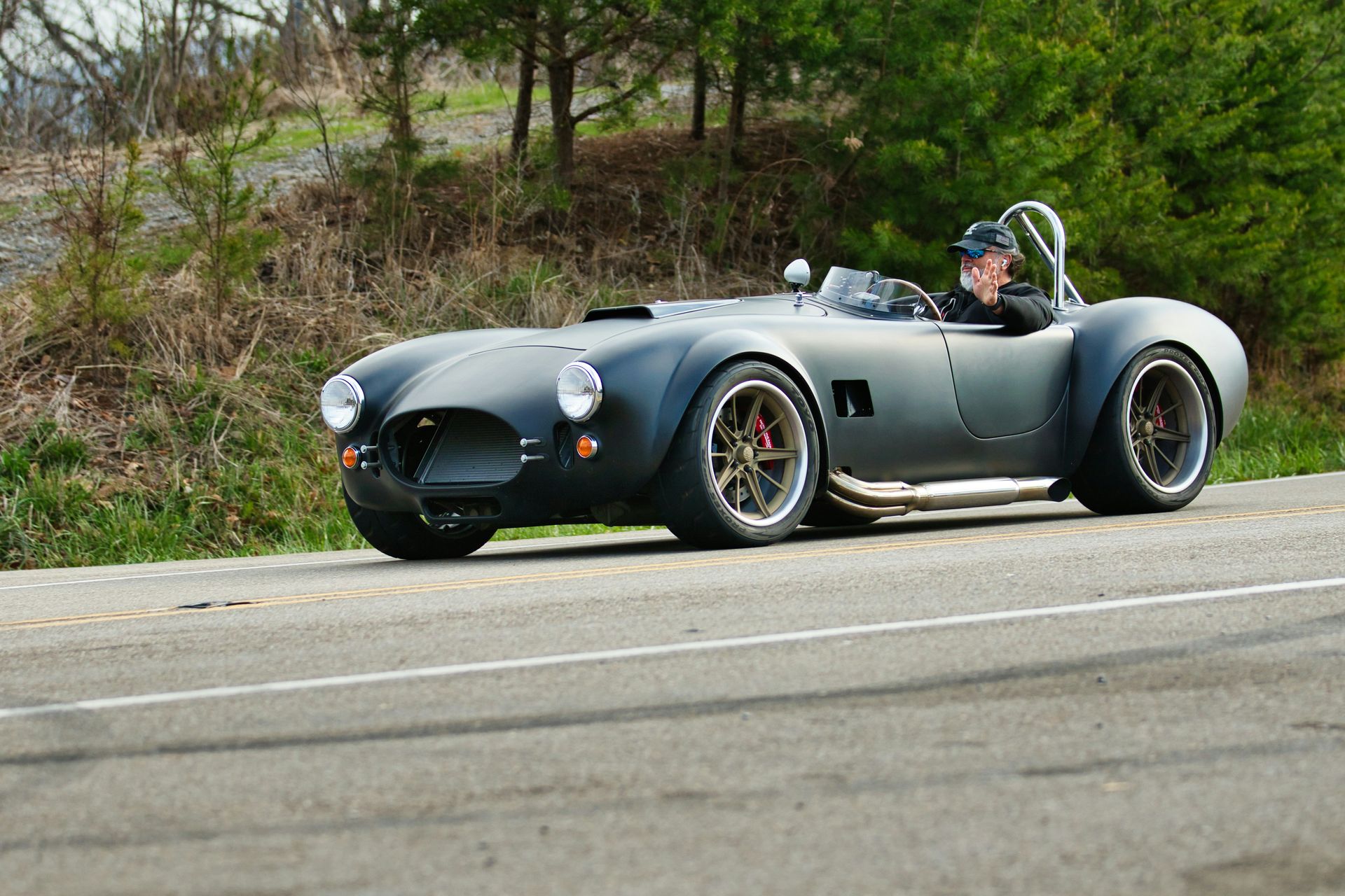 Man in gray hoodie consoles woman in white shirt on a couch.