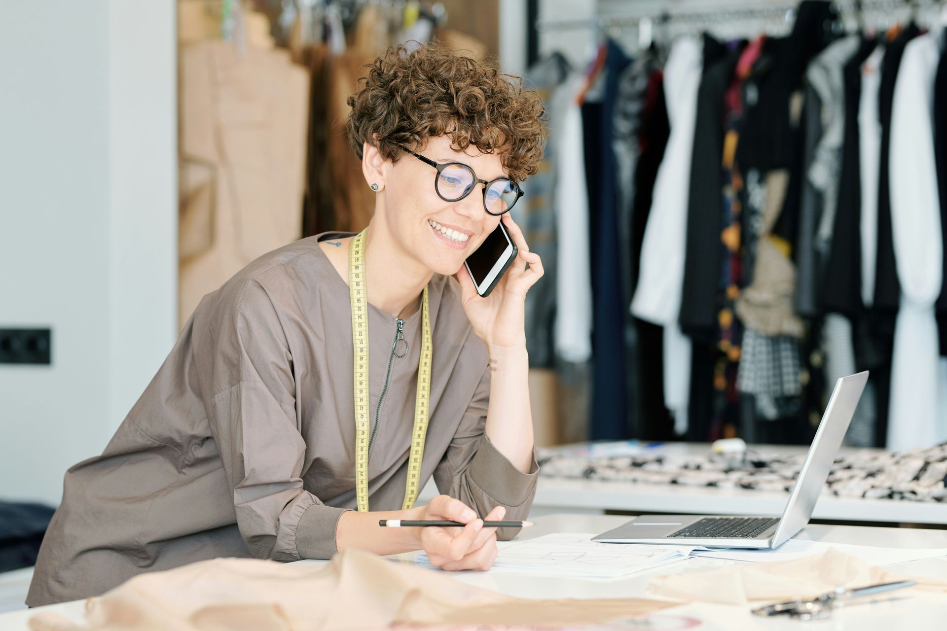 Man in gray hoodie consoles woman in white shirt on a couch.
