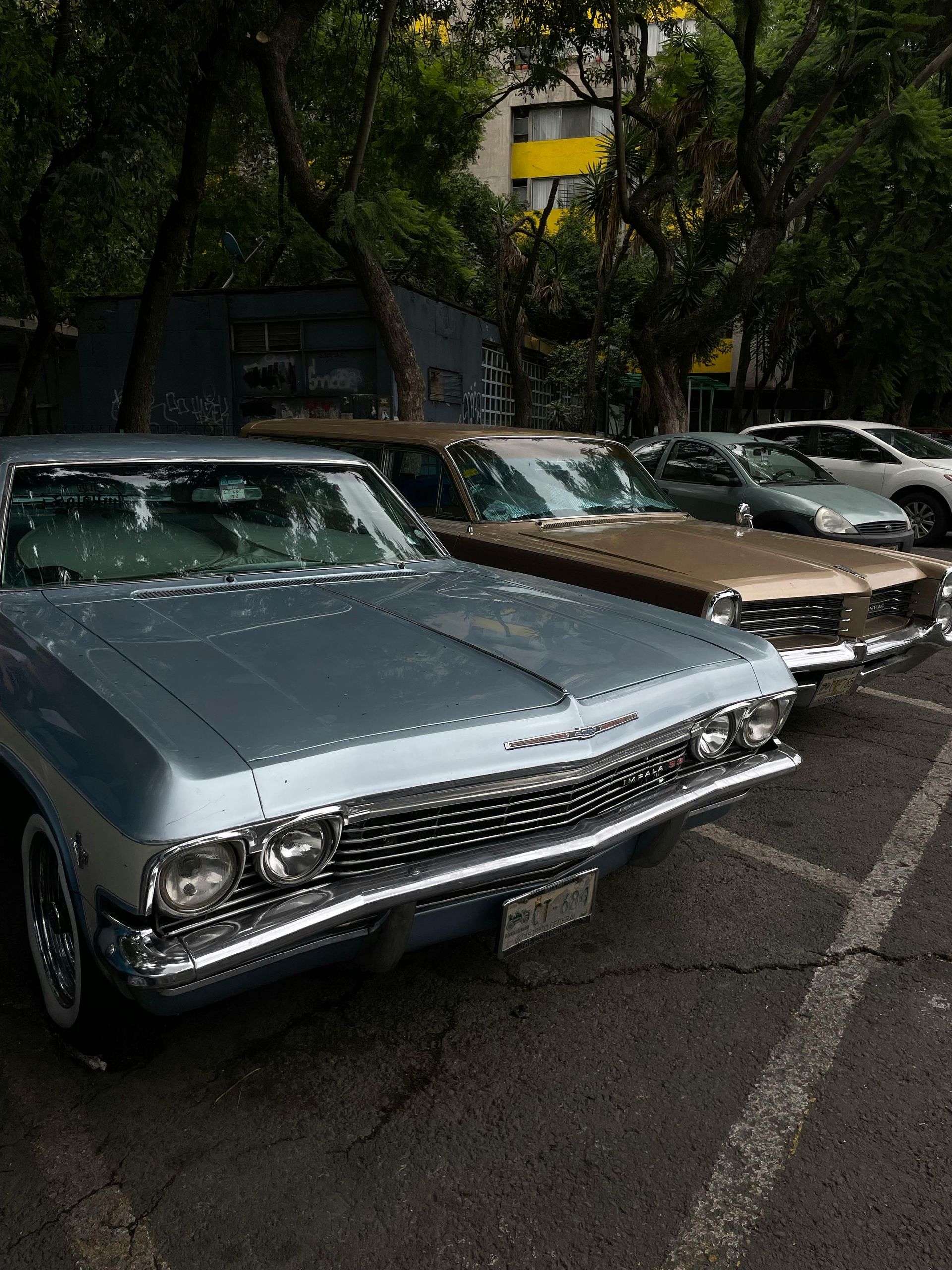 People signing documents at a table with a gavel, possibly in a legal setting.