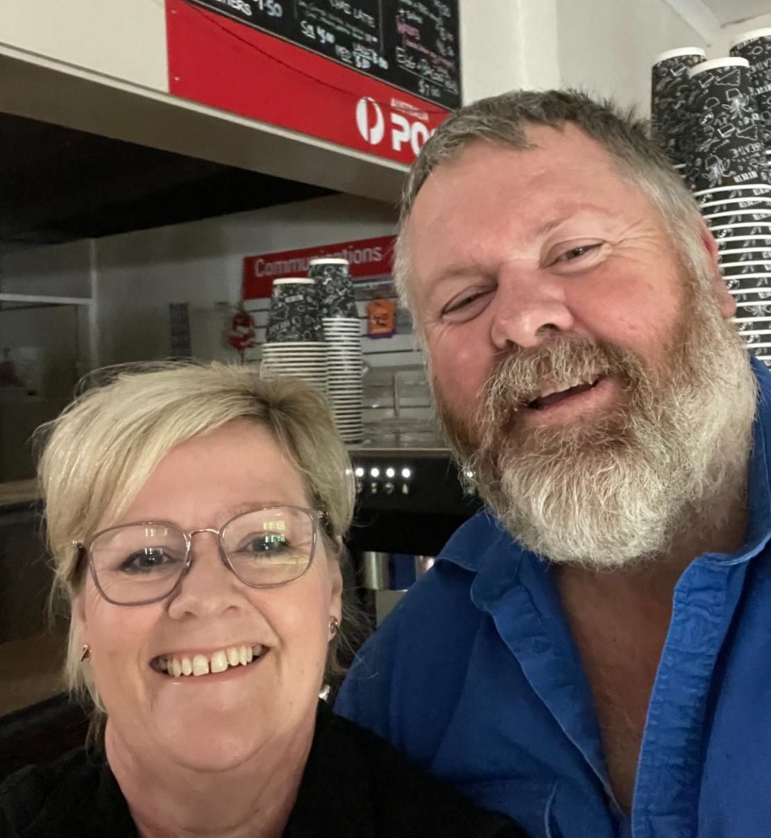A Man And A Woman Are Posing For A Picture In Front Of An AusPost Sign — Geurie General Store In Geurie, NSW