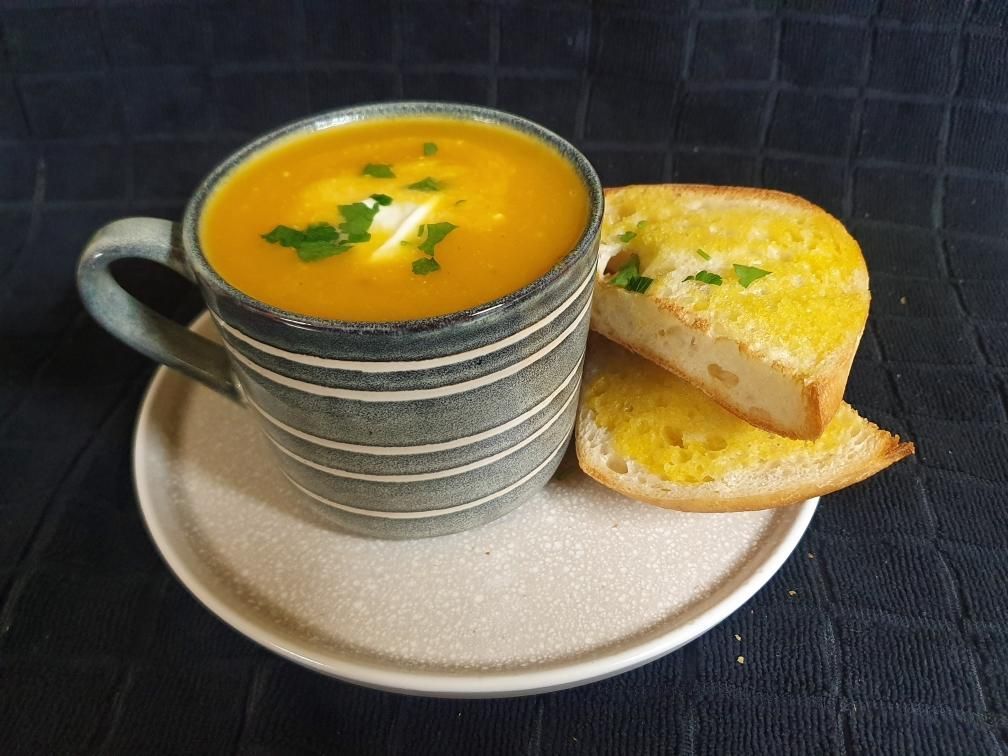 A Cup Of Soup With Garlic Bread On A Plate — Geurie General Store In Geurie, Nsw