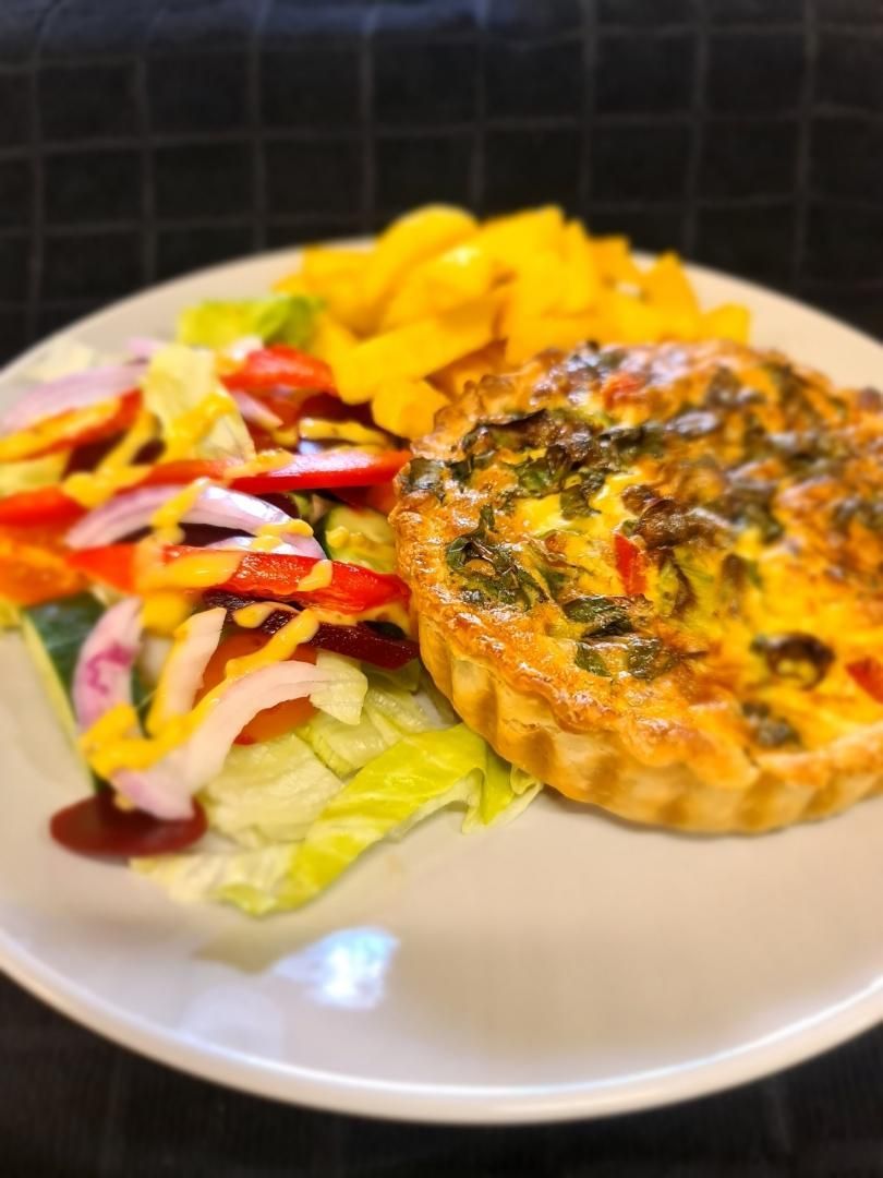 A White Plate Topped With A Quiche And A Salad — Geurie General Store In Geurie, NSW