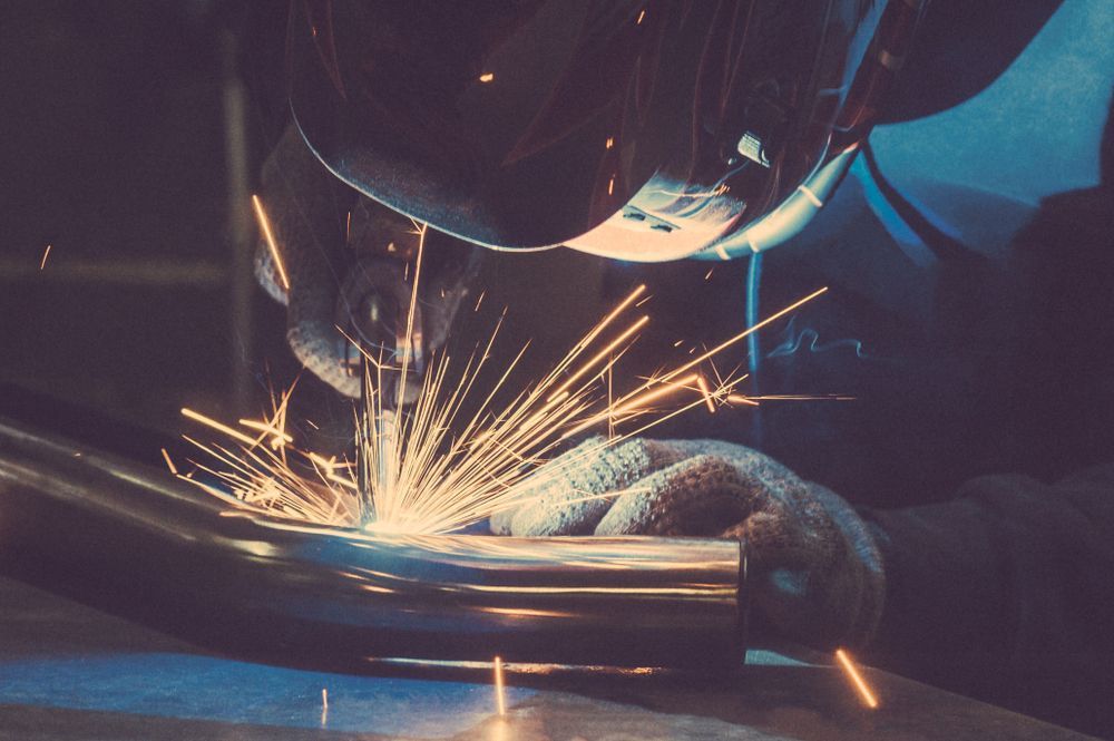 A Man is Welding a Piece of Metal With Sparks — Barry Smith Engineering Pty Ltd in Coffs Harbour, NSW