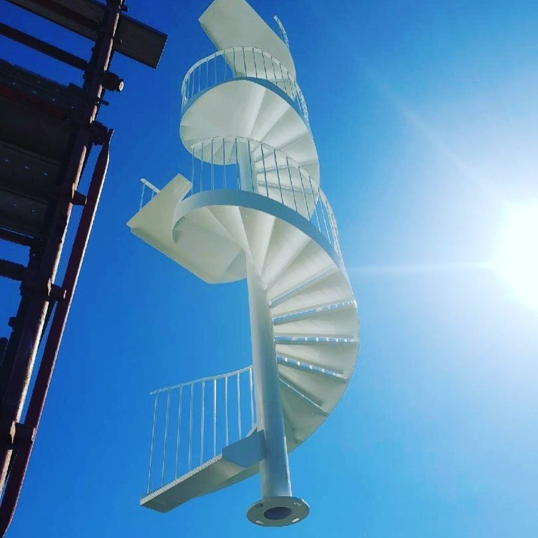 A White Spiral Staircase Against a Blue Sky — Barry Smith Engineering Pty Ltd in Coffs Harbour, NSW