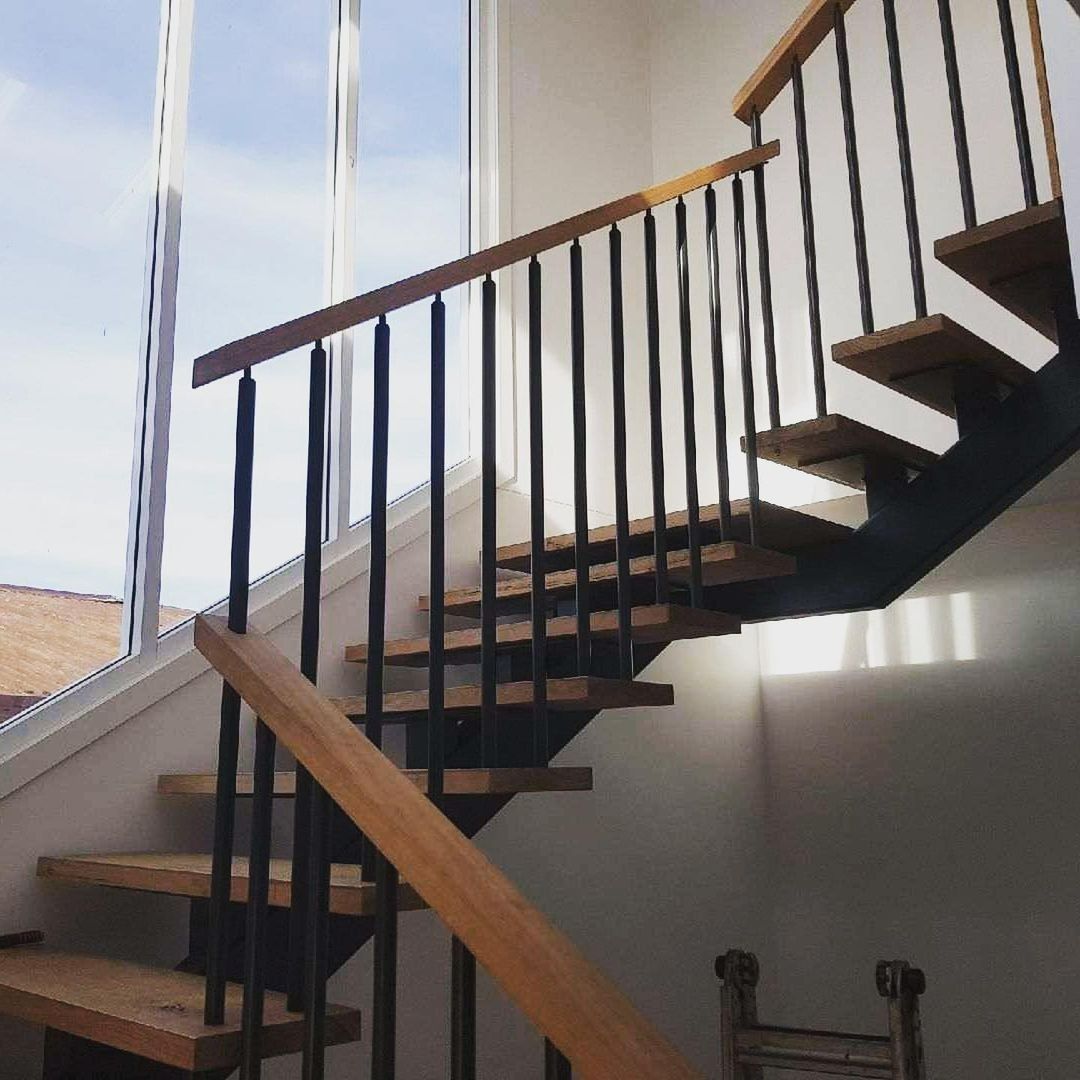 A Staircase With Wooden Steps and a Metal Railing — Barry Smith Engineering Pty Ltd in Coffs Harbour, NSW
