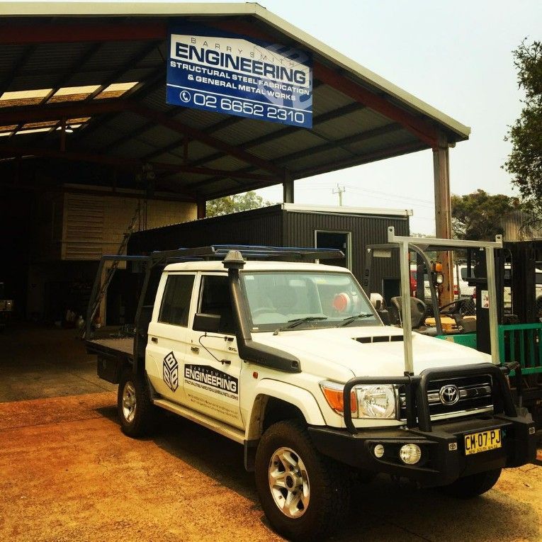 A White Truck is Parked in Front of a Building — Barry Smith Engineering Pty Ltd in Coffs Harbour, NSW