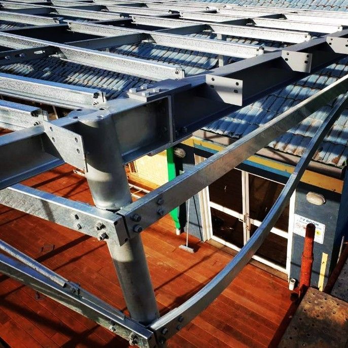 A Metal Structure is Being Built on Top of a Wooden Deck — Barry Smith Engineering Pty Ltd in Coffs Harbour, NSW