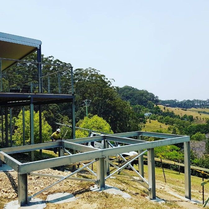 A Structure is Sitting on Top of a Hill Next to a House — Barry Smith Engineering Pty Ltd in Coffs Harbour, NSW