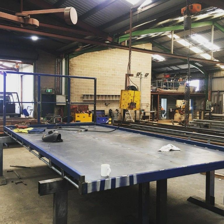 A Blue Table in a Factory With a Cup on It — Barry Smith Engineering Pty Ltd in Coffs Harbour, NSW