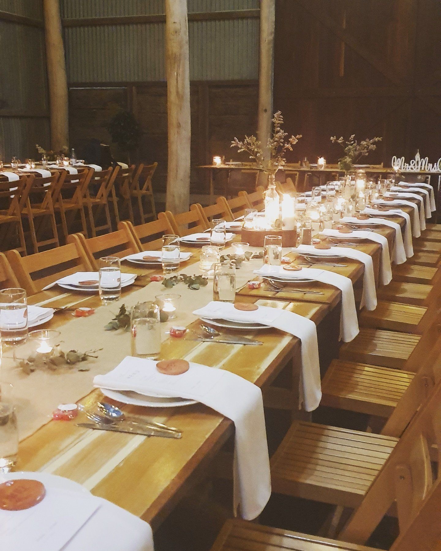 A long table with plates and candles on it