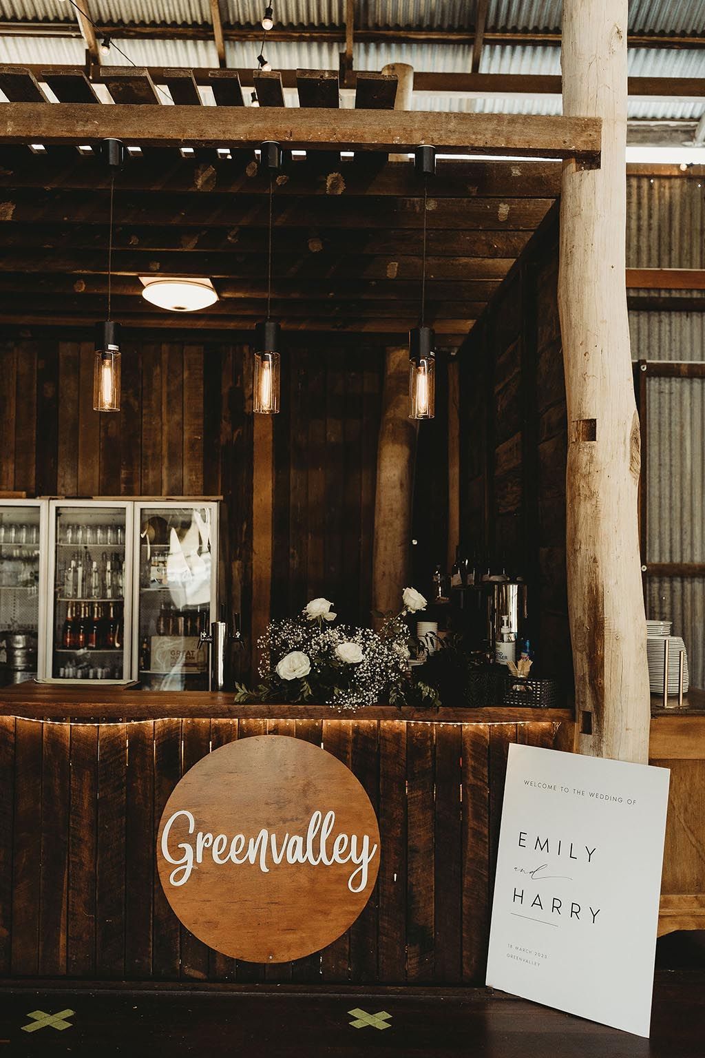A wooden bar with a sign that says `` green valley '' on it.