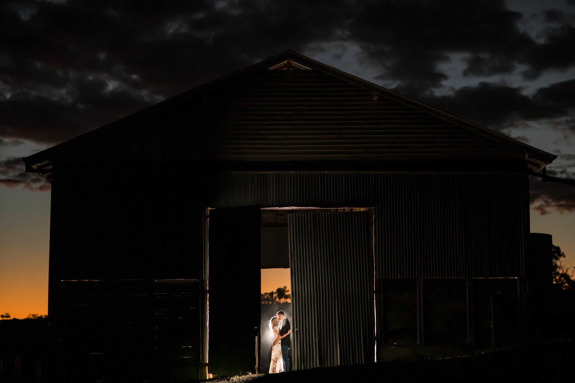 Greenvalley Bride and Groom at Night in Barn Doorway