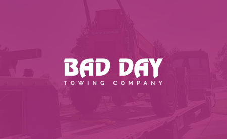 Overhead view of a dark gray roof, with a green and yellow logo featuring a stylized house and the letter