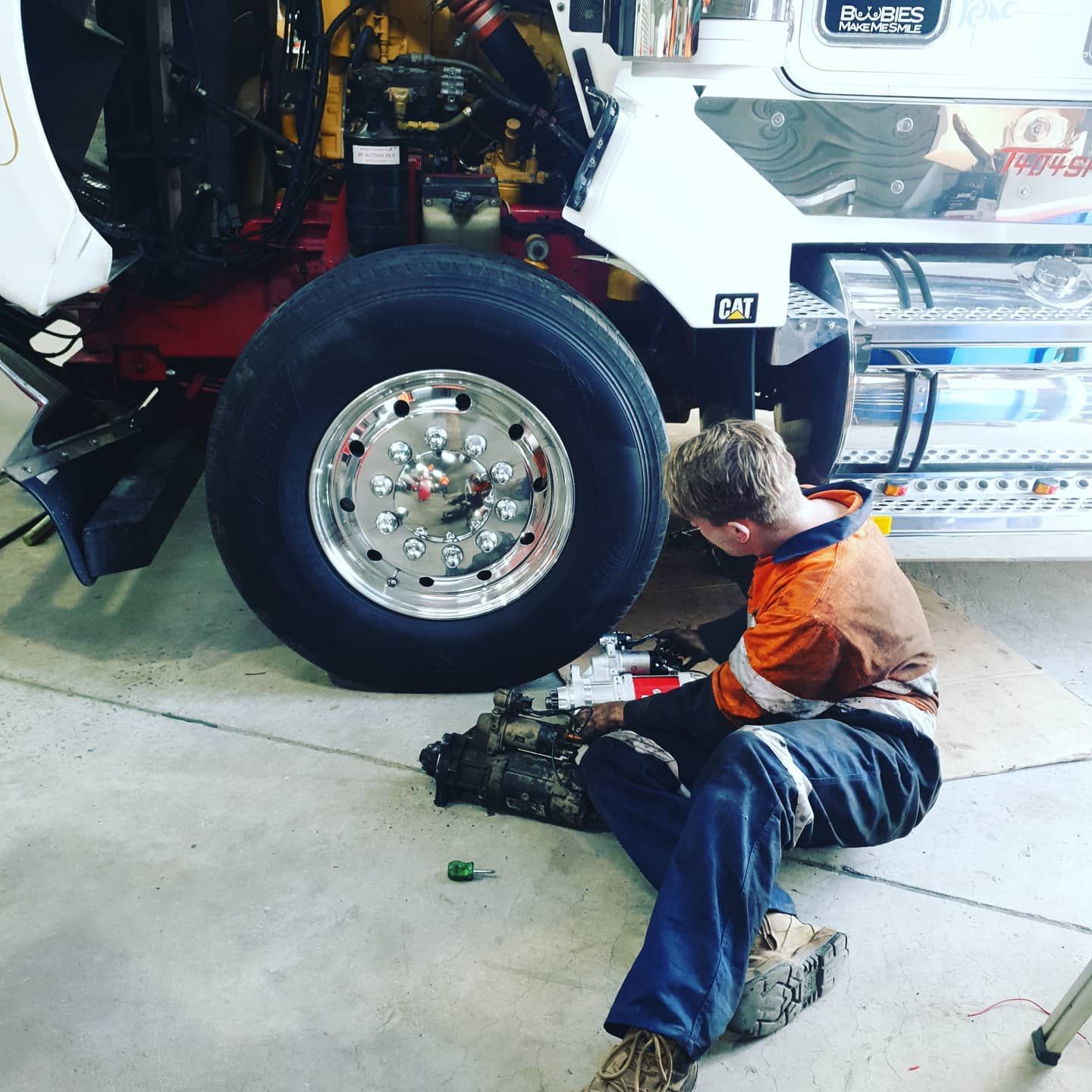 Mechanic Working on the Undercarriage of a Truck in a Garage — Auto Watt in Kelso, NSW