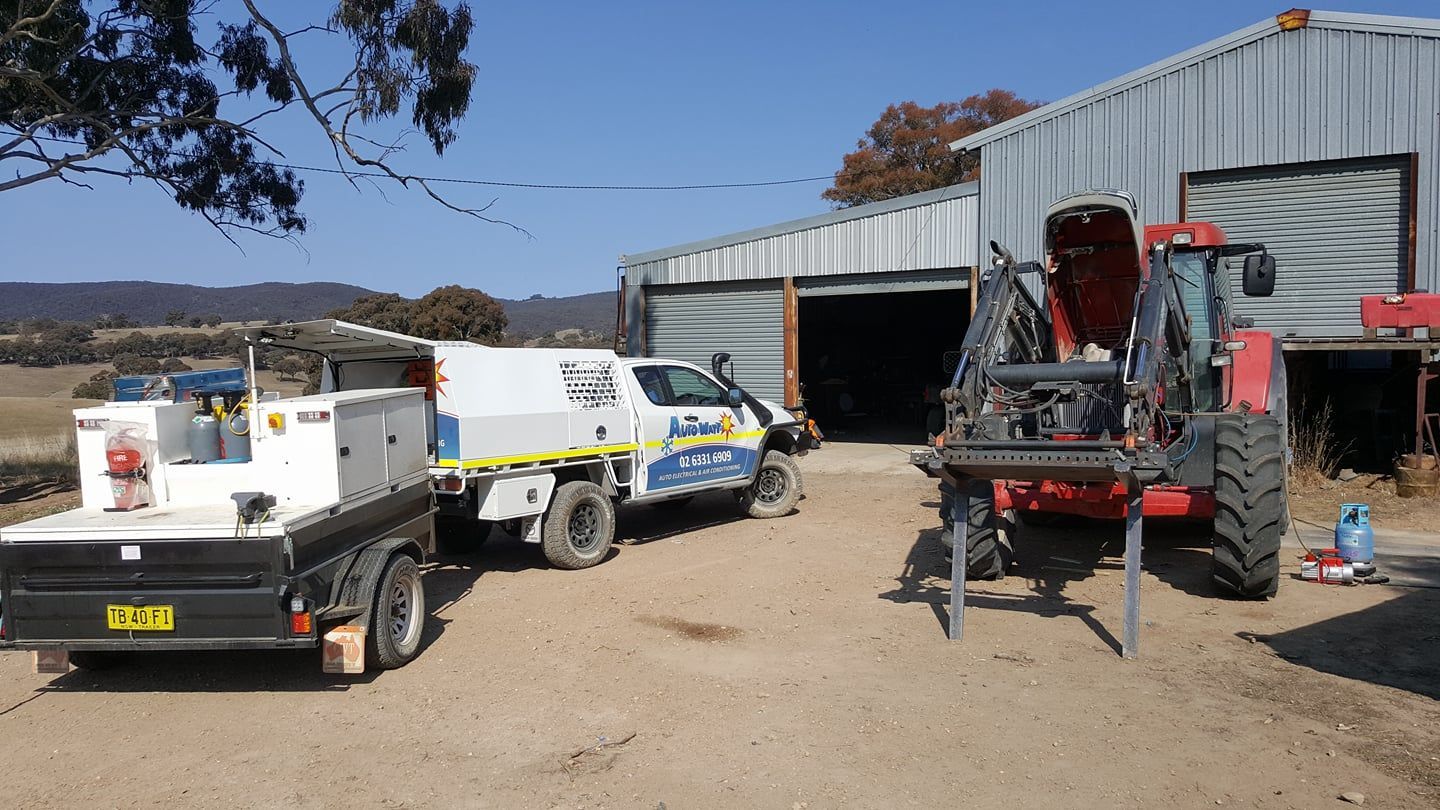 Truck and Trailer With a Forklift in Front of a Barn on a Rural Property — Auto Watt in Kelso, NSW