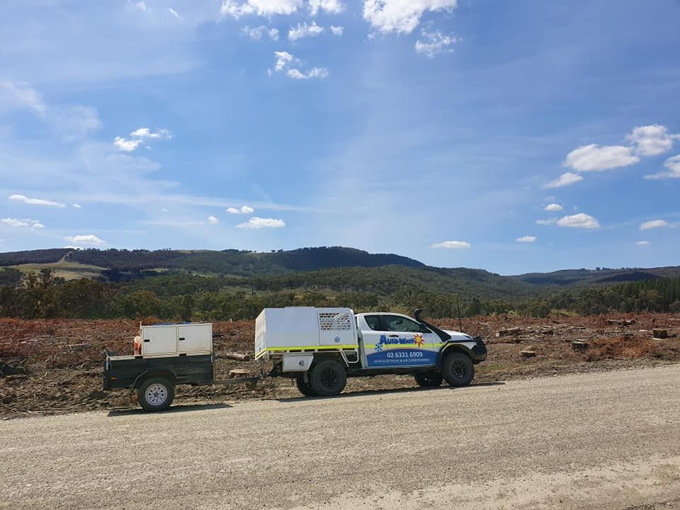 Truck With Trailer Parked on Dirt Road in Front of Deforested Hills Under a Blue Sky — Auto Watt in Kelso, NSW