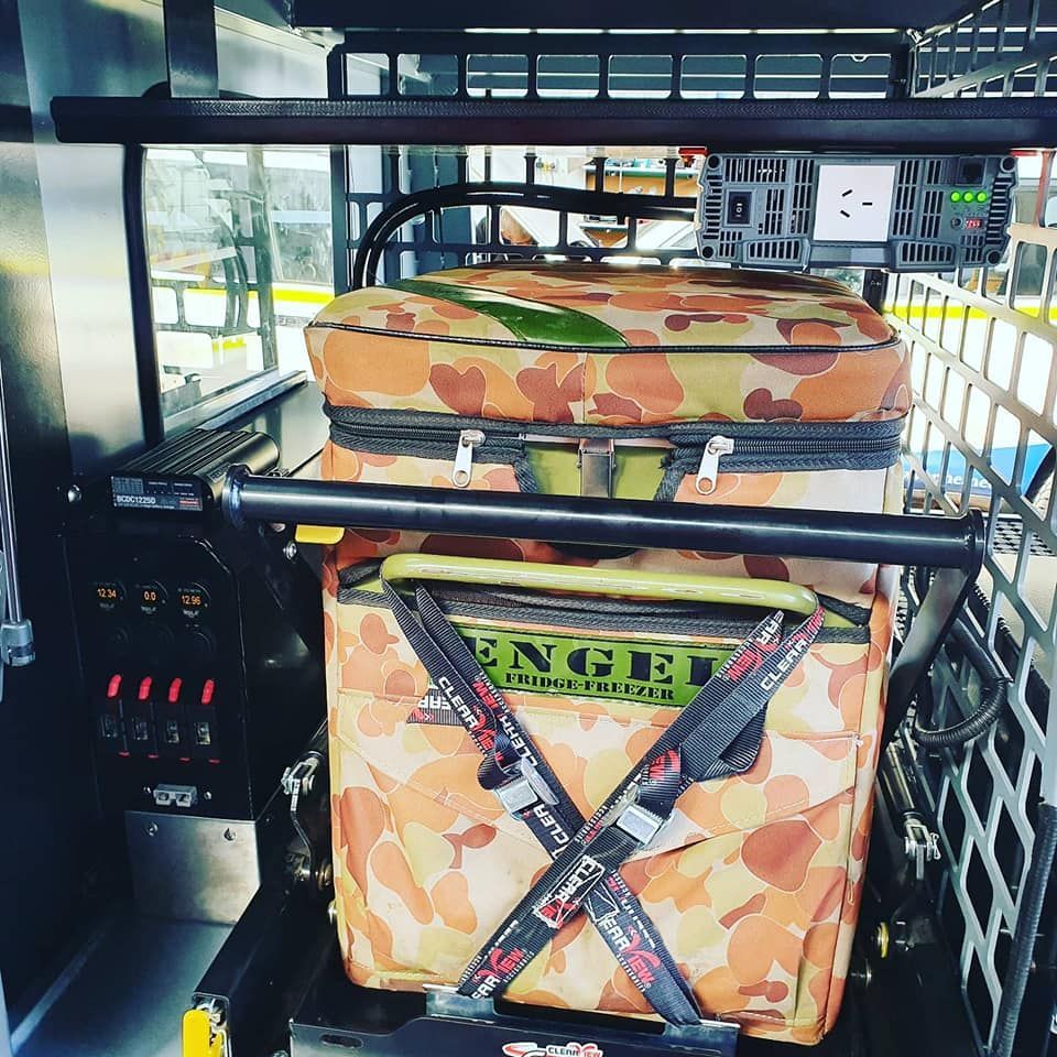 Two Camouflaged Coolers Secured Inside a Vehicle With Metal Framing — Auto Watt in Kelso, NSW