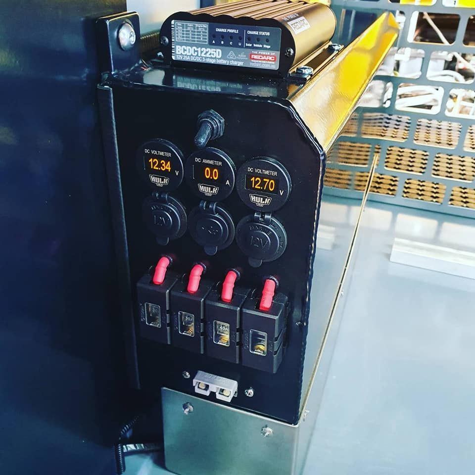 Black Metal Panel With Power Outlets, Switches, and Digital Displays in a Vehicle — Auto Watt in Kelso, NSW