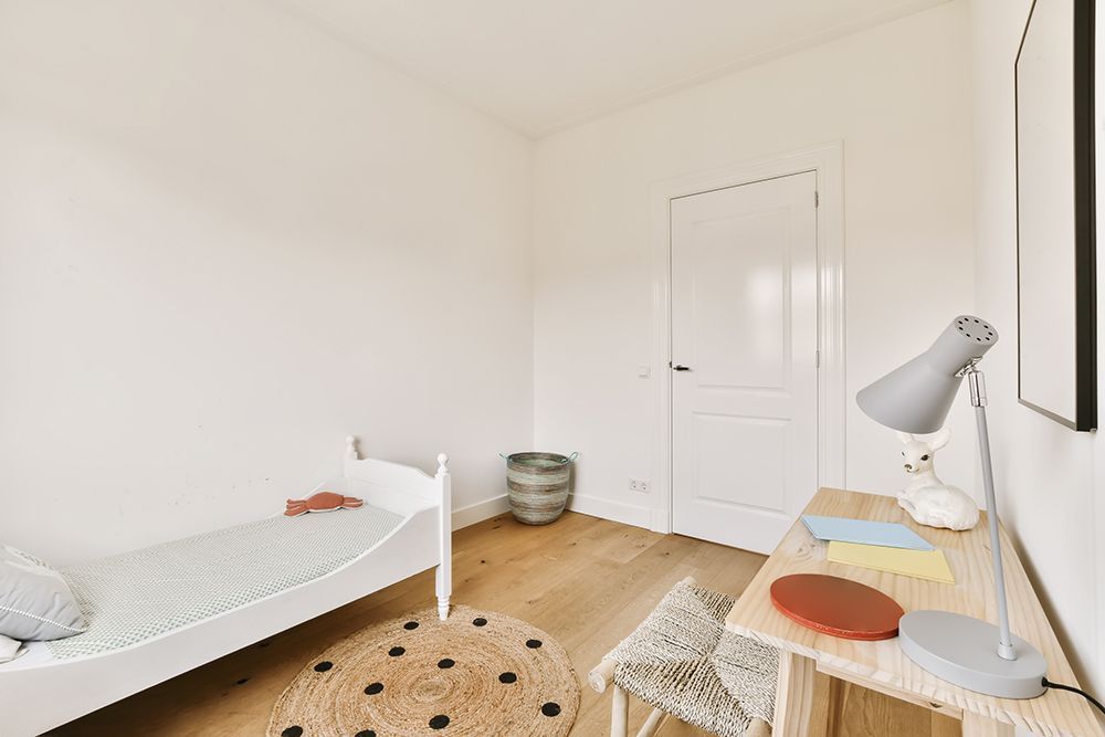 a bedroom with a bed and a desk