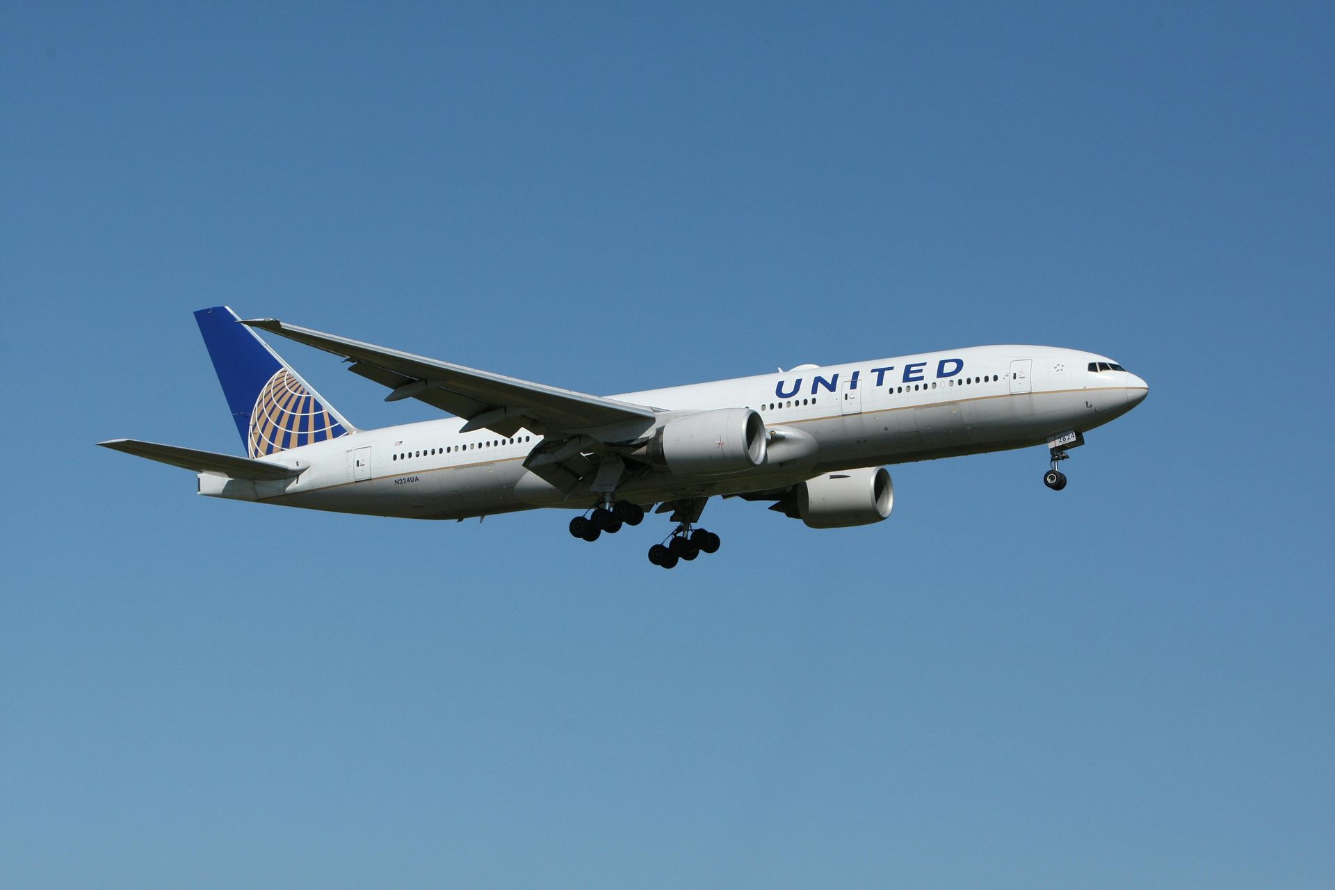 A united airlines plane is flying in the sky