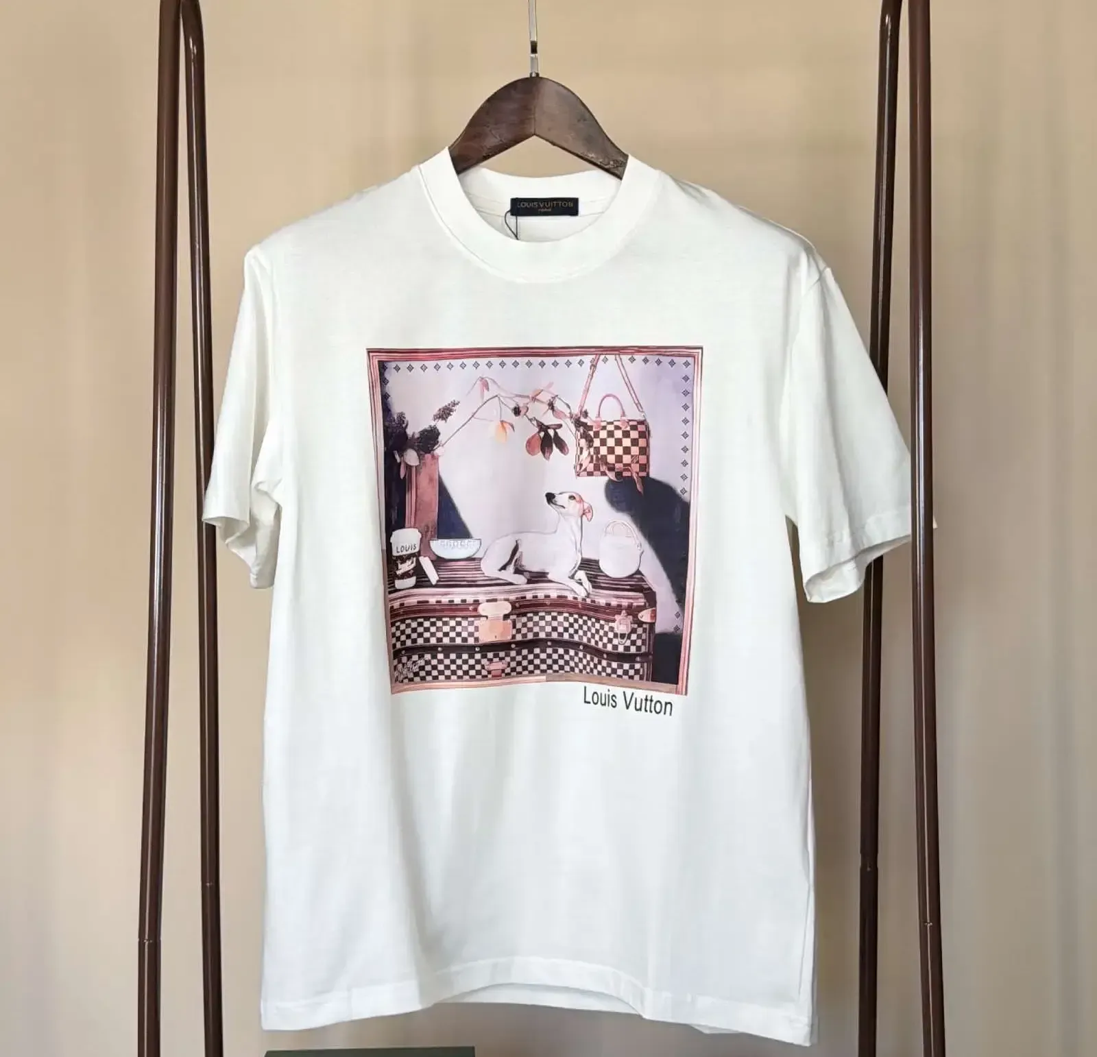 White LVE t-shirt with a printed design, a basketball, and a designer box on a logo-patterned surface.