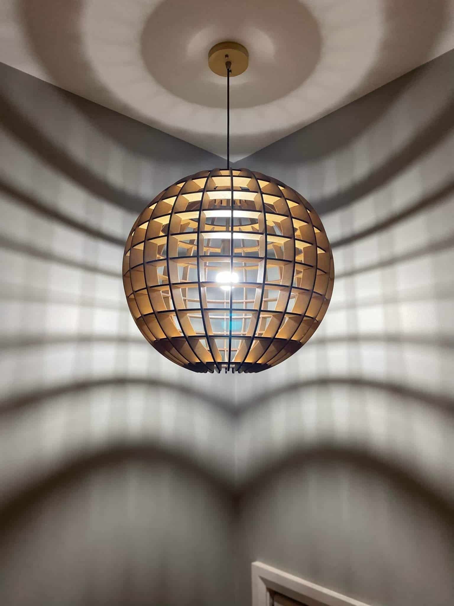 A Wooden Chandelier Is Hanging from The Ceiling in A Room  — KPJ Electrical In Charlestown, NSW