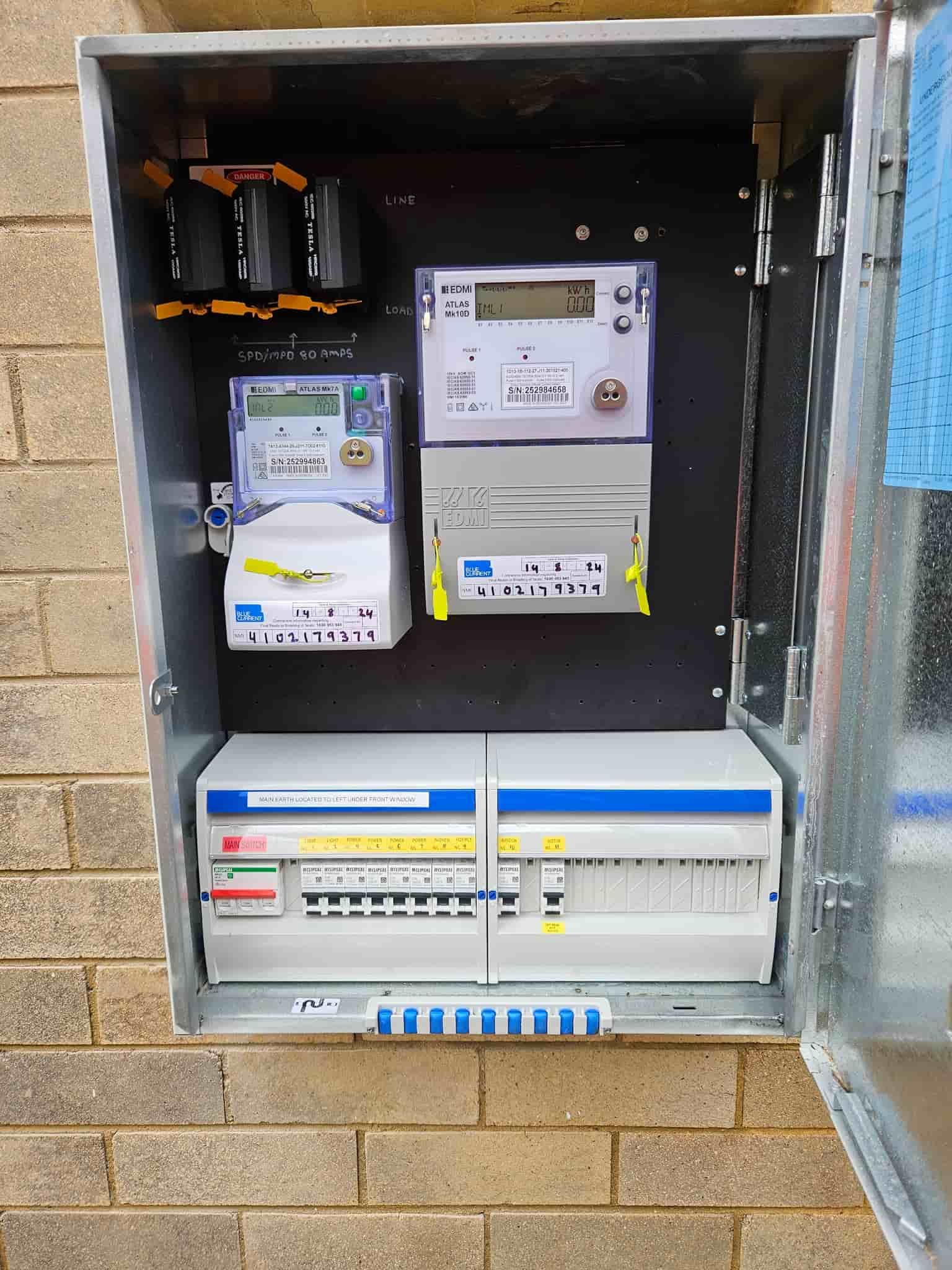 A Brick Wall with A Metal Box Filled with Electrical Equipment  — KPJ Electrical In Charlestown, NSW