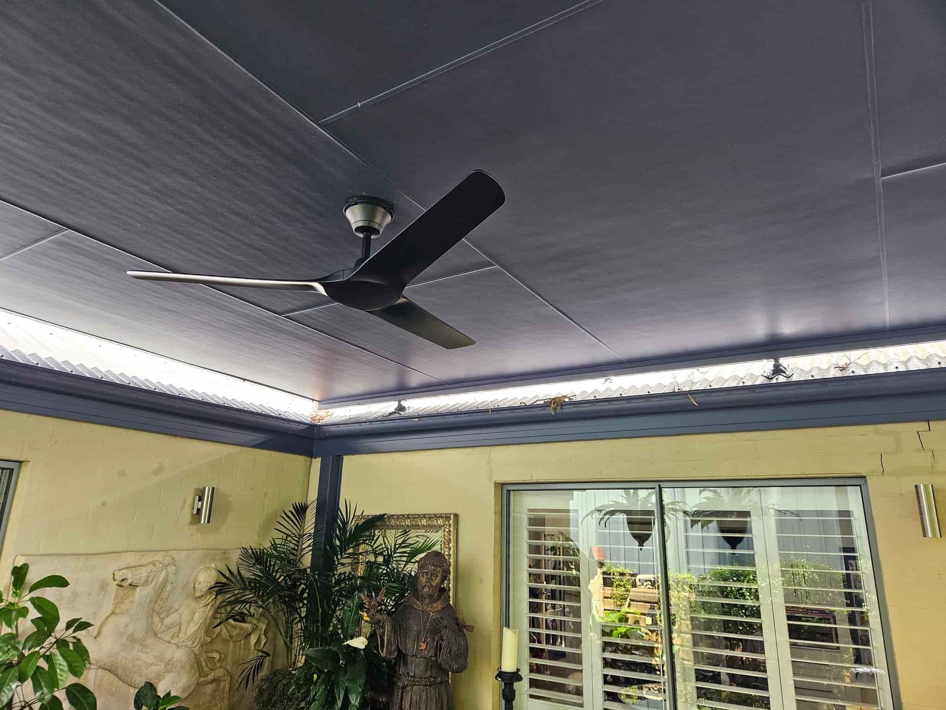 A Ceiling Fan Is Hanging from The Ceiling of A Room  — KPJ Electrical In Charlestown, NSW