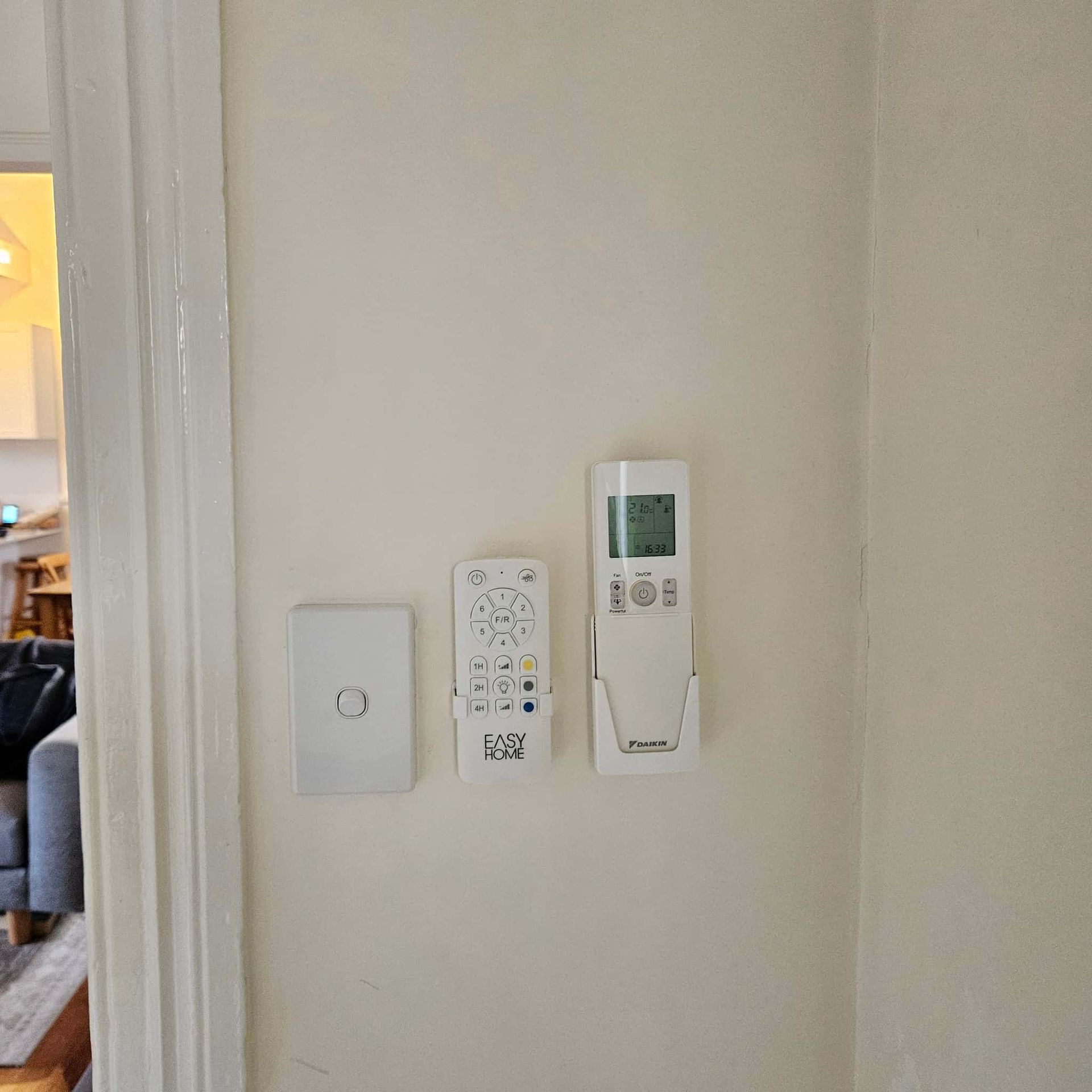 A Remote Control Is Hanging on A Wall Next to A Light Switch  — KPJ Electrical In Charlestown, NSW