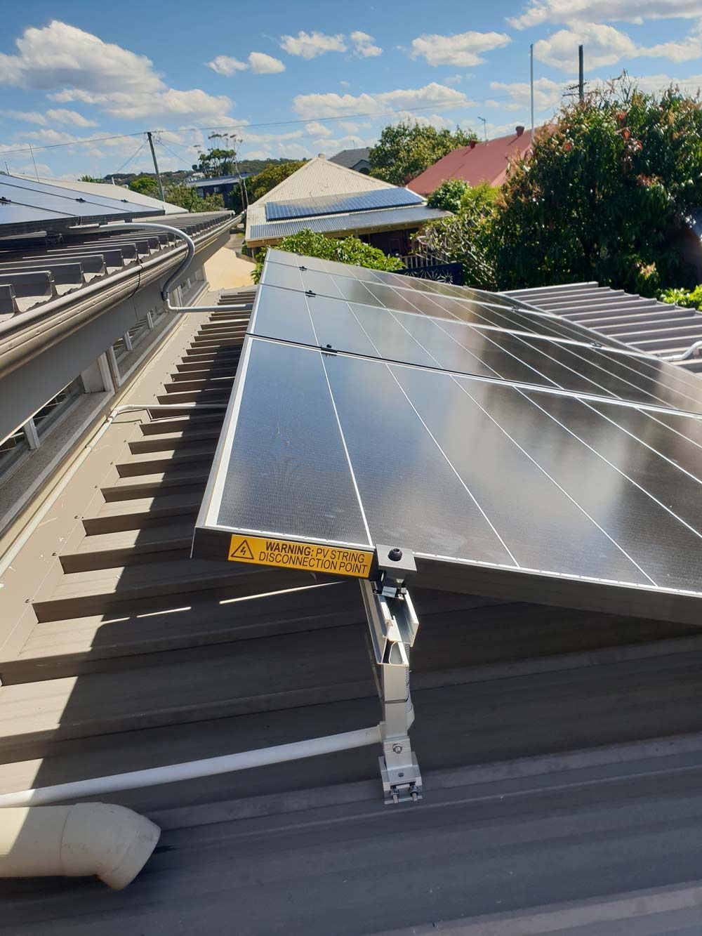 Solar Panels With PV String Disconnection Point Warning — KPJ Electrical In Charlestown New South Wales