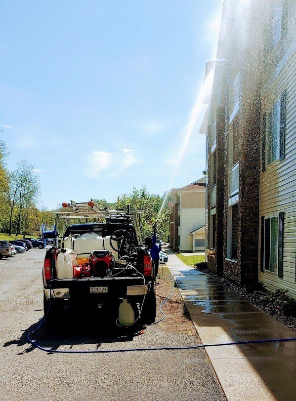 Pressure Washing siding and windows of house exterior