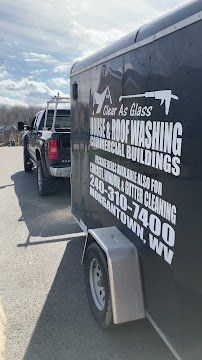 Pressure Washing siding and roof of white house exterior