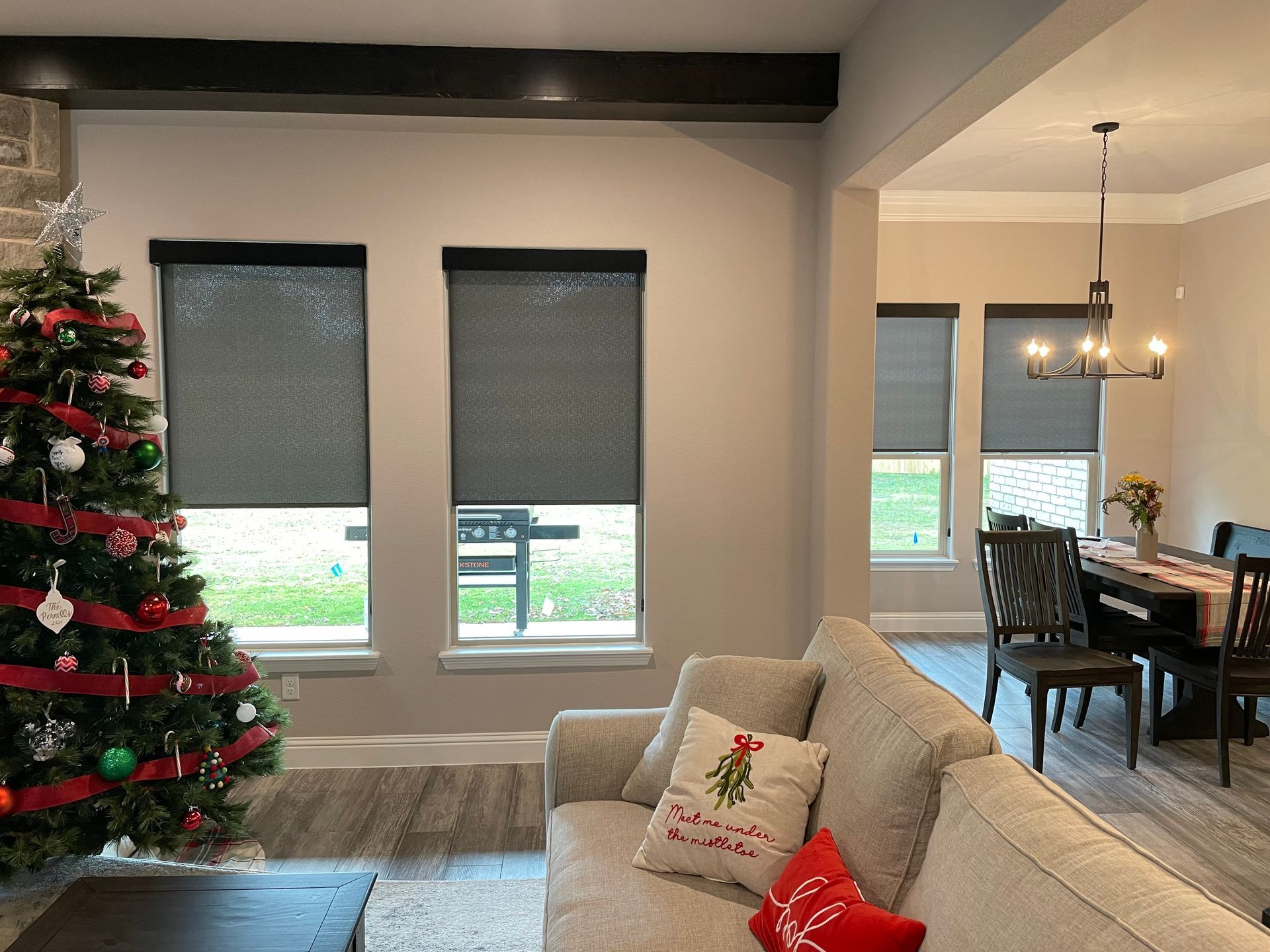 A living room with a couch and a christmas tree.