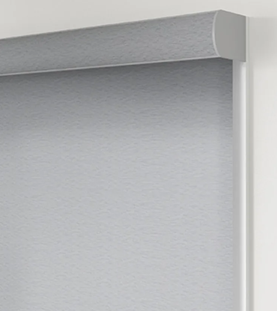 A close up of a roller blind on a window.