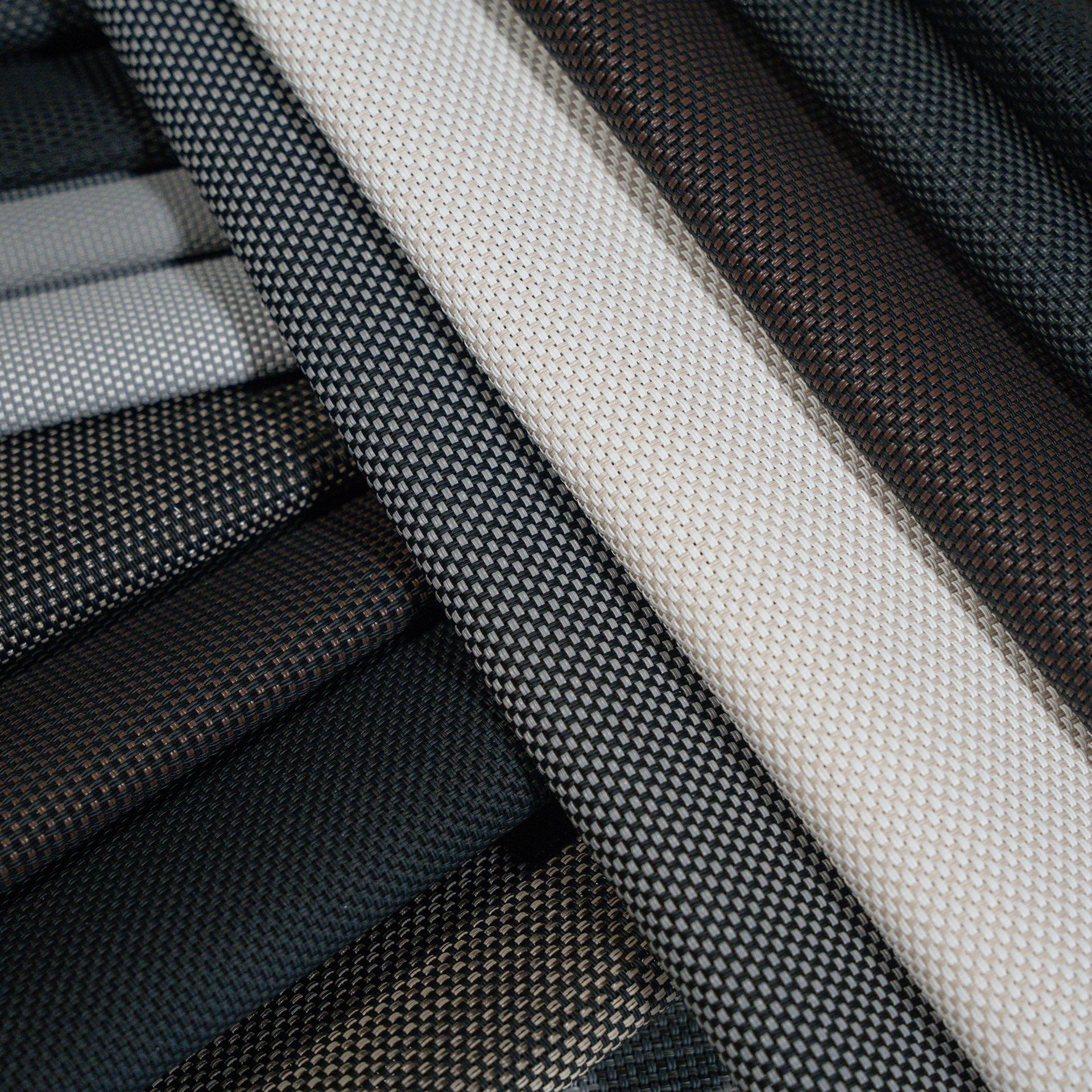 A bunch of different colored fabrics are stacked on top of each other.