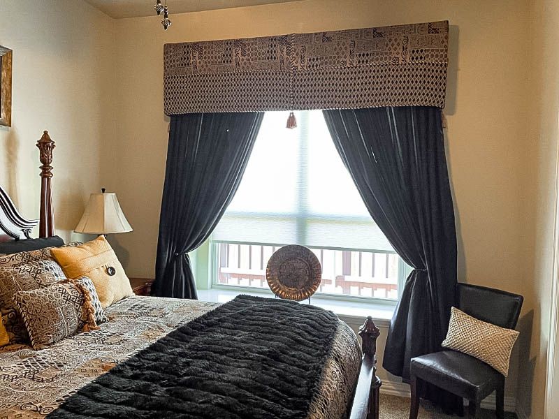 Love is Blinds - shades and drapery in a bedroom.